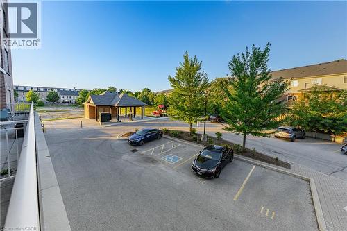 Outdoor parking area with paved surfaces, mature trees, and a covered gazebo structure - 155 Water Street S Unit# 203, Cambridge, ON - Outdoor