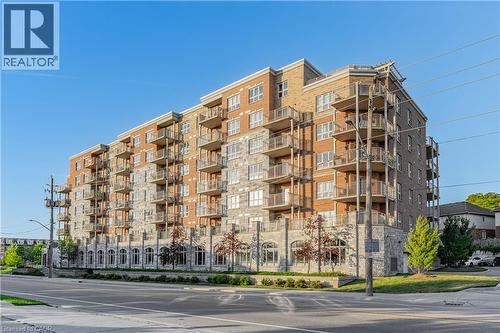 Contemporary multi-story building featuring extensive brick and stone cladding - 155 Water Street S Unit# 203, Cambridge, ON - Outdoor With Facade
