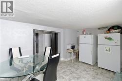 Kitchen area featuring tile flooring, white walls, and a recessed doorway - 