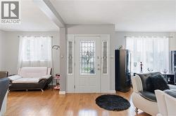 Entryway featuring a white door with leaded glass, flanked by two sidelights with decorative glass - 