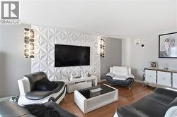 Feature wall with dimensional geometric panels and integrated wall sconces - 