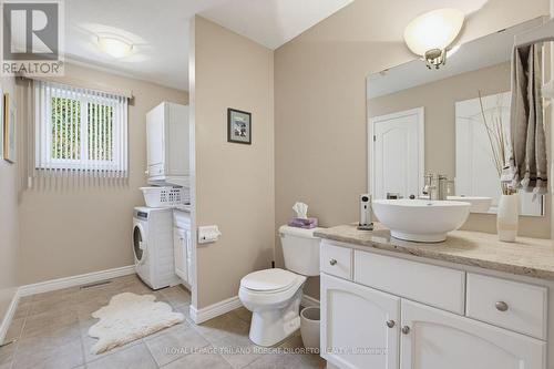 main floor powder room & laundry - 9989 Oxbow Drive, Middlesex Centre (Komoka), ON - Indoor Photo Showing Bathroom