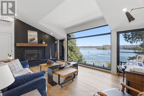 Wood Buring Fireplace - 1311 S. Ril Lake Road, Lake Of Bays (Ridout), ON - Indoor Photo Showing Living Room With Fireplace With Body Of Water