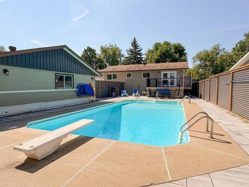 54 Darrach Bay, Brandon, MB - Outdoor With In Ground Pool With Deck Patio Veranda With Exterior