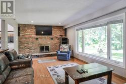 Living room with brick wood burning fireplace. - 