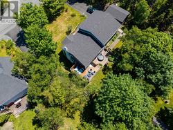 Aerial Rear of House with private 0.5+ acre treed private lot, patios and calmness - 