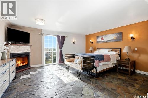 308 3Rd Street W, Delisle, SK - Indoor Photo Showing Bedroom With Fireplace