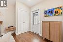 Entryway featuring wood-finish flooring, a white paneled door with decorative glass inserts, and a closet with bifold doors - 715 Drury Lane, Burlington, ON  - Indoor Photo Showing Other Room 