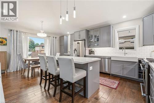 Spacious kitchen featuring wood-finish flooring and grey cabinetry - 715 Drury Lane, Burlington, ON - Indoor