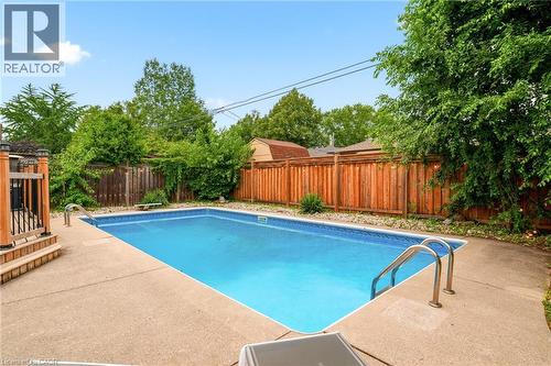 Rectangular inground pool with concrete surround - 715 Drury Lane, Burlington, ON - Outdoor With In Ground Pool With Backyard