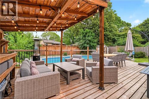 Expansive wood deck with a built-in pergola featuring string lighting - 715 Drury Lane, Burlington, ON - Outdoor With Deck Patio Veranda With Exterior