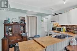 Kitchen showing Fridge & Utility Closet w/ Furnace - 