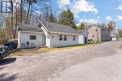 Main House, storage shed, duplex with beige siding - 