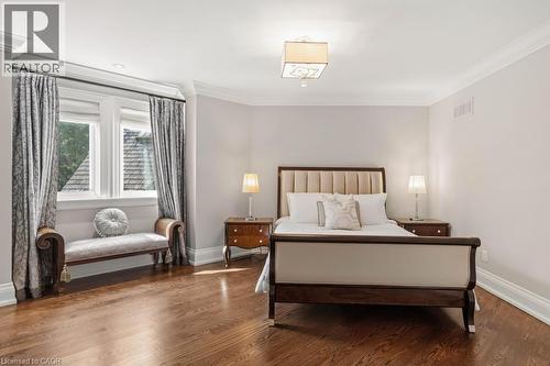 Hardwood flooring throughout featuring a bay window with a window seat, crown molding, and a recessed light fixture - 4038 Lakeshore Road, Burlington, ON - Indoor Photo Showing Bedroom