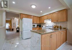 Kitchen with granite counters and ample cabinets - 