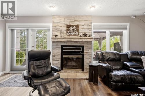 18 Forman Bay, Regina, SK - Indoor Photo Showing Living Room With Fireplace