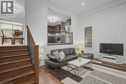 Hardwood staircase with dark metal spindles and wood-finish handrail - 