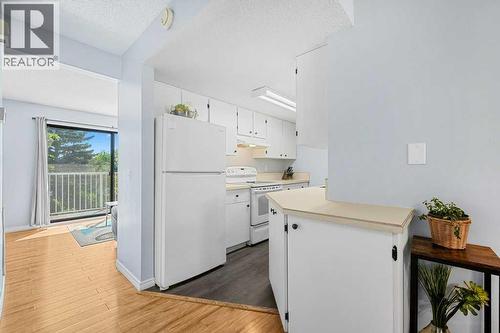 newer fridge - 80, 1055 72 Avenue Nw, Calgary, AB - Indoor Photo Showing Kitchen