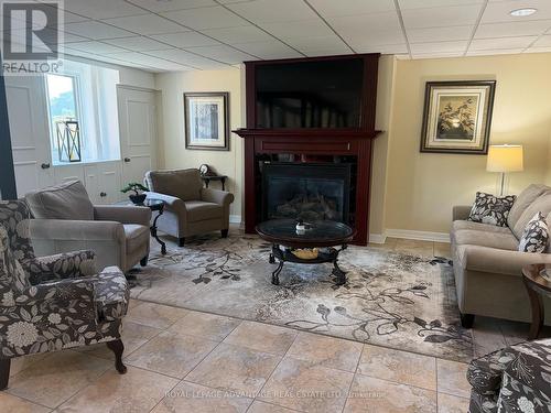 104 - 41 Sunset Boulevard, Perth, ON - Indoor Photo Showing Living Room With Fireplace