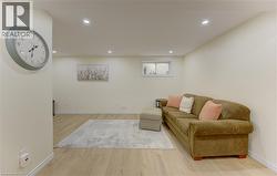Neutral-toned room featuring recessed lighting and wood-finish flooring - 