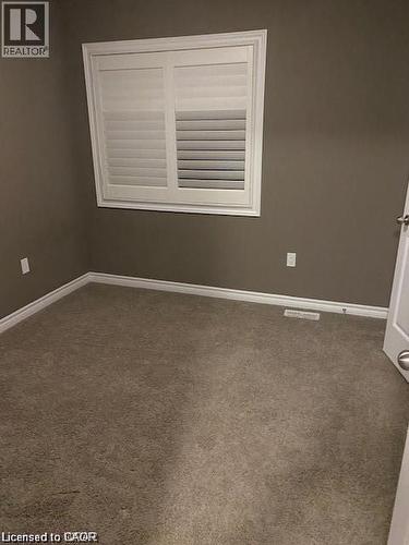 Room featuring carpet flooring, painted walls, and white trim - 4 Isaiah Drive, Kitchener, ON - Indoor Photo Showing Other Room