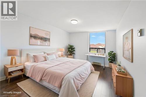 Spacious room featuring dark wood-finish flooring, a large window with horizontal blinds, and recessed lighting - 688 Preston Parkway Unit# 401, Cambridge, ON - Indoor Photo Showing Bedroom