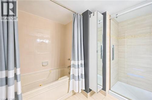 Built-in tub with jets and light-toned wall tiling - 688 Preston Parkway Unit# 401, Cambridge, ON - Indoor Photo Showing Bathroom