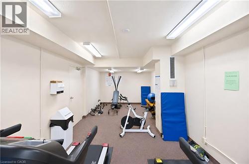 Dedicated fitness area with commercial carpet flooring and fluorescent lighting - 688 Preston Parkway Unit# 401, Cambridge, ON - Indoor Photo Showing Gym Room