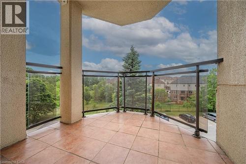 Outdoor balcony featuring expansive tile flooring and a clear glass railing system - 688 Preston Parkway Unit# 401, Cambridge, ON - Outdoor With Exterior
