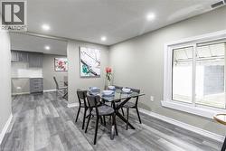 Dining area featuring wood-finish flooring, recessed lighting, and a sliding window - 