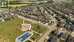 Expansive residential community featuring a public park with a playground and sports court, established streetscapes, and varied home styles - 