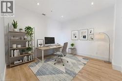 Virtually staged. Bright room featuring wood-finish flooring, white walls, and recessed lighting - 