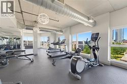 Fitness area featuring textured rubber flooring and exposed ductwork - 