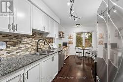 White Cabinetry with modern Stainless Steel Pulls - 