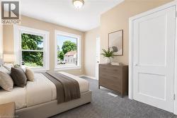 Bedroom with neutral wall tones and textured carpeting - 