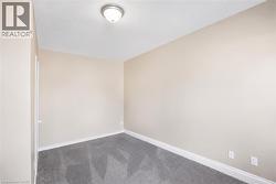 Neutral-toned walls complement the grey carpeting - 
