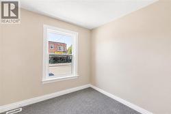 Neutral-toned walls complement the gray carpeting - 