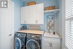 Main Floor Laundry with storage and shelving - 
