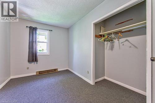 Room featuring light gray painted walls, dark gray carpet flooring, and white baseboards - 819 Duke Street, Cambridge, ON - Indoor Photo Showing Other Room