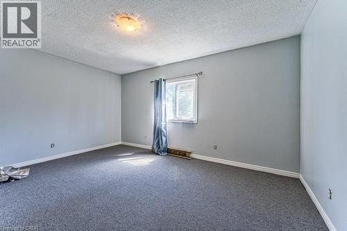 Spacious room featuring light gray walls, plush gray carpeting, and white baseboards - 819 Duke Street, Cambridge, ON - Indoor Photo Showing Other Room