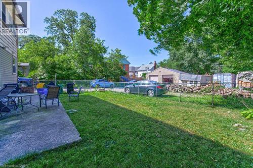 Rear yard with a concrete patio, a grass lawn, and a chain-link fence - 819 Duke Street, Cambridge, ON - Outdoor