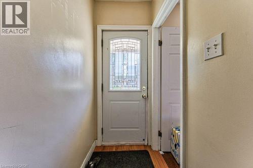 White entry door with an arched decorative glass insert - 819 Duke Street, Cambridge, ON - Indoor Photo Showing Other Room