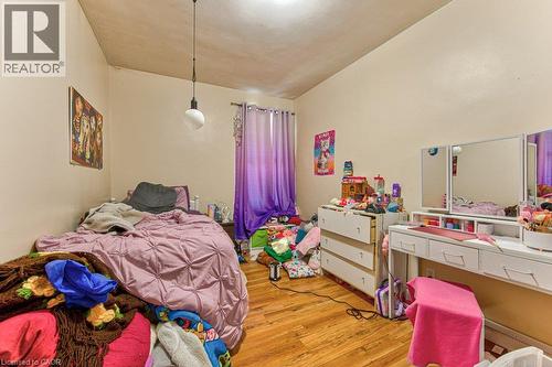 Wood-finish flooring with a pendant light fixture - 819 Duke Street, Cambridge, ON - Indoor Photo Showing Bedroom