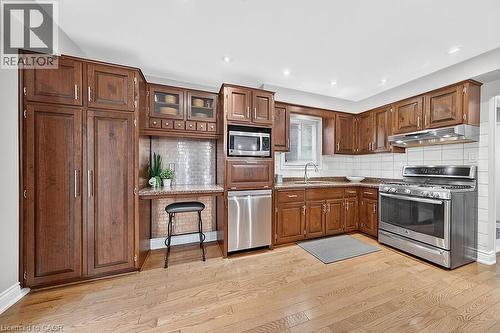 Kitchen featuring wood-finish flooring and recessed lighting - 30 Carriagegate Drive, Hamilton, ON - Indoor Photo Showing Kitchen With Stainless Steel Kitchen With Double Sink