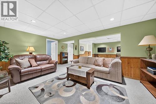 Spacious room featuring paneled wainscoting, recessed lighting, and a suspended ceiling - 30 Carriagegate Drive, Hamilton, ON - Indoor Photo Showing Living Room