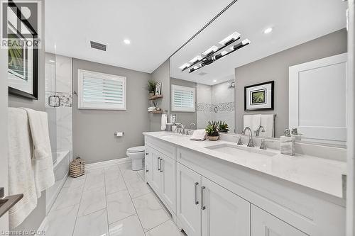 Dual vanity with integrated sinks and white countertops - 30 Carriagegate Drive, Hamilton, ON - Indoor Photo Showing Bathroom