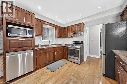 Kitchen featuring wood-finish flooring, recessed lighting, and rich wood cabinetry - 30 Carriagegate Drive, Hamilton, ON - Indoor Photo Showing Kitchen With Stainless Steel Kitchen