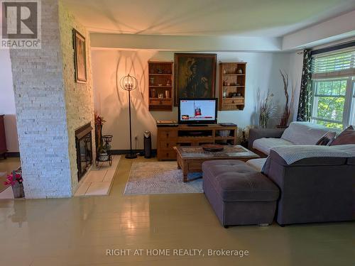 D-7 - 1663 Nash Road, Clarington, ON - Indoor Photo Showing Living Room With Fireplace