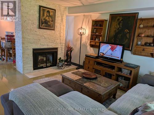 D-7 - 1663 Nash Road, Clarington, ON - Indoor Photo Showing Living Room With Fireplace