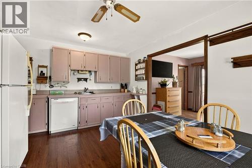 Kitchen area featuring wood-finish flooring, a white refrigerator, a white dishwasher, and pink cabinetry with a light-colored countertop - 958 Highland Road E, Hamilton, ON 